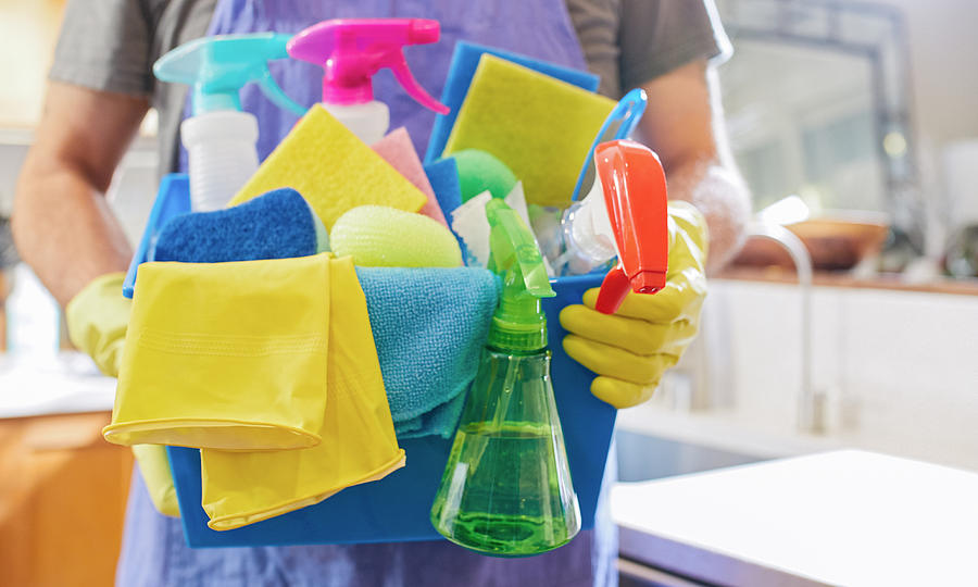 A House Cleaner Holding Cleaning And Sanitizing Utilities For Kitchen Worktop And Surfaces Cleaning Thanasis