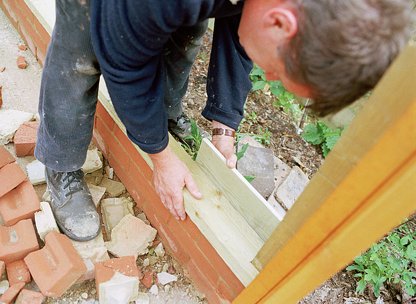 Man Building Things Man Building A Wall Greeting Card by Martin Riedl / Science Photo Library