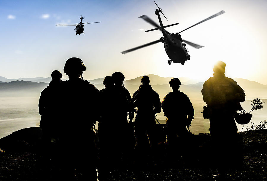 Silhouettes of soldiers during Military Mission at dusk #1 Photograph by Guvendemir
