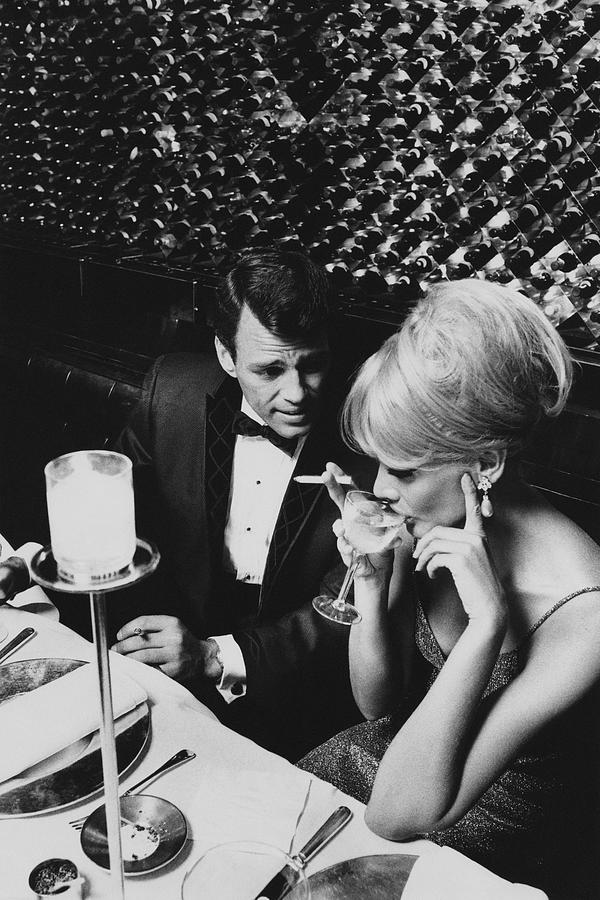 Elegant Evening at a Glamorous Restaurant Photograph - A Glamorous 1960s Couple Dining by Horn & Griner