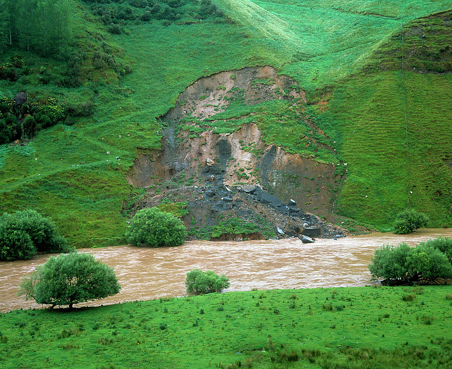 Flooded River Eroding Its Bank by Simon Fraser / Science Photo Library
