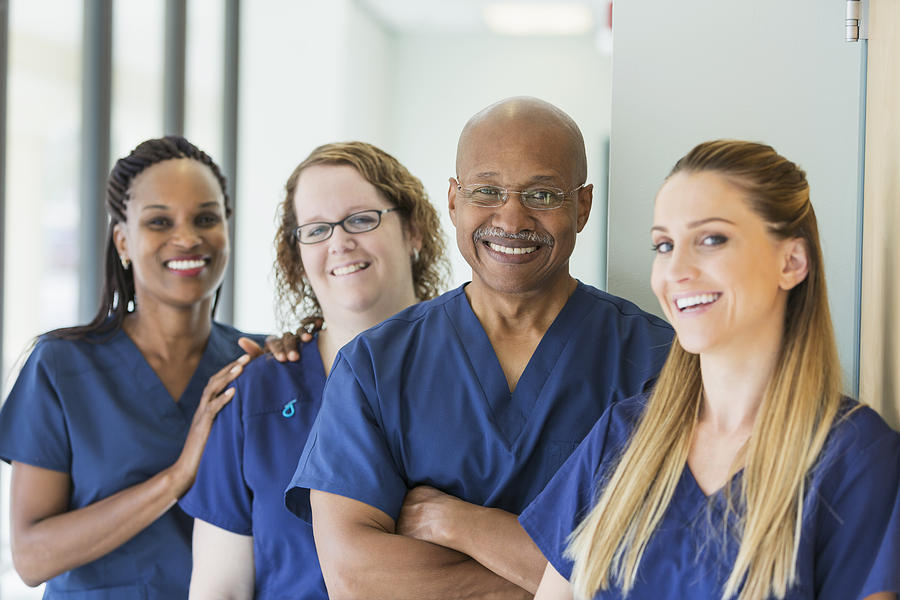 Man leading team of multi-ethnic medical professionals Photograph by Kali9