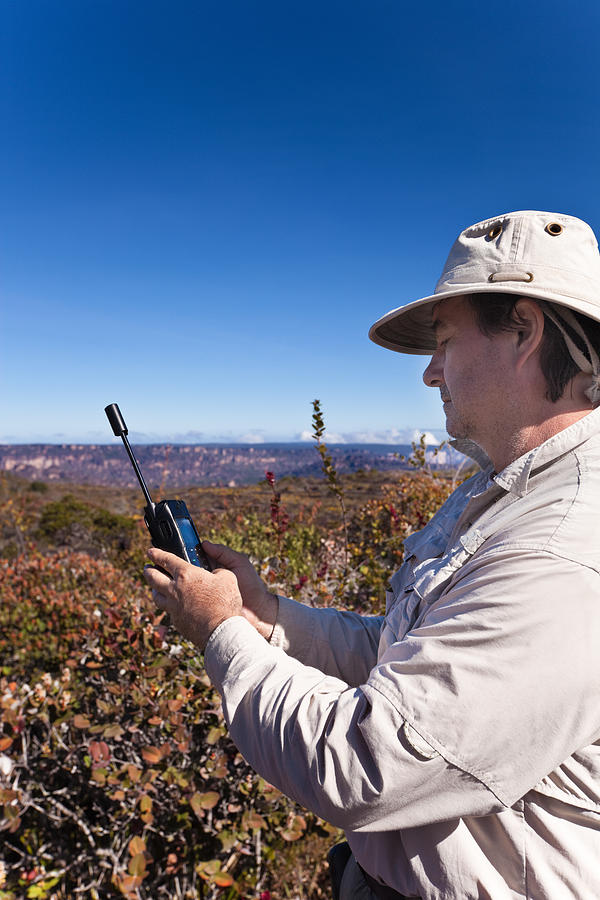 Man with satellite phone Photograph by Apomares