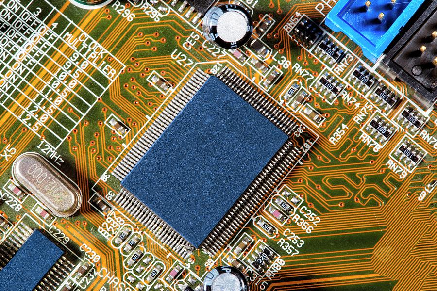 M Chip Computer Micro Chip And Mother Board by Christian Lagerek / Science Photo Library