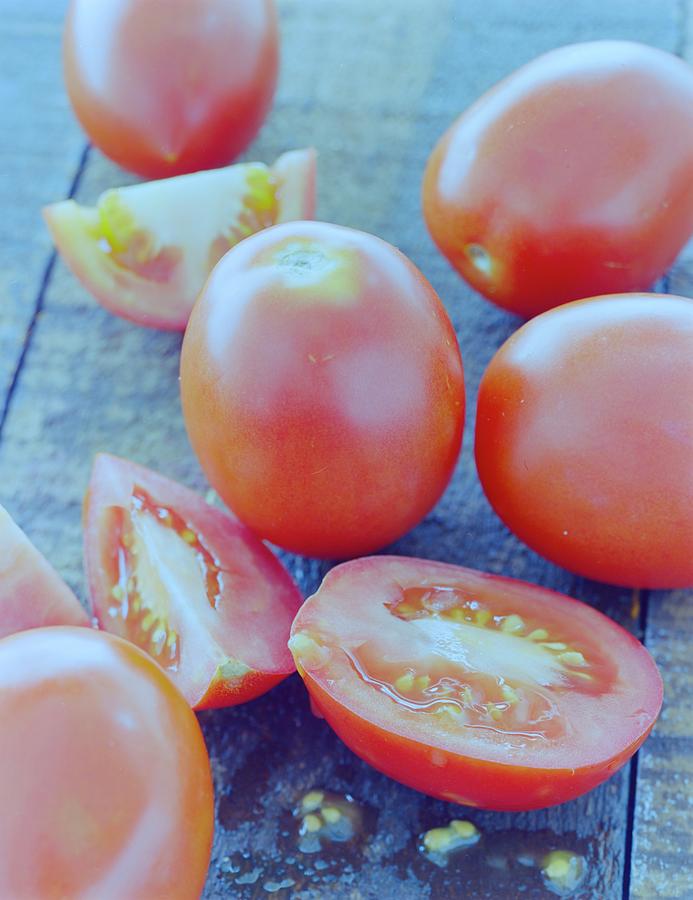 Rustic Tomatoes on Wooden Surface Photograph - Plum Tomatoes On A Wooden Board by Romulo Yanes