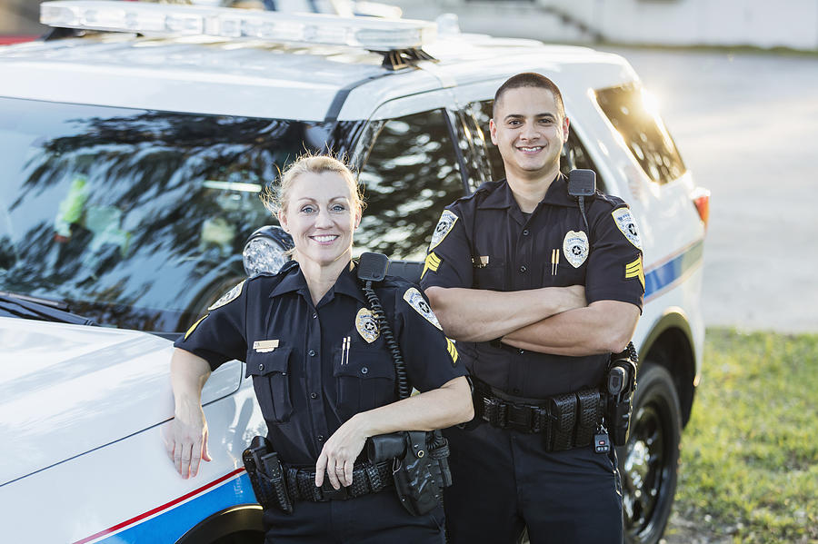 Policewoman And Partner Next To Squad Car Kali9