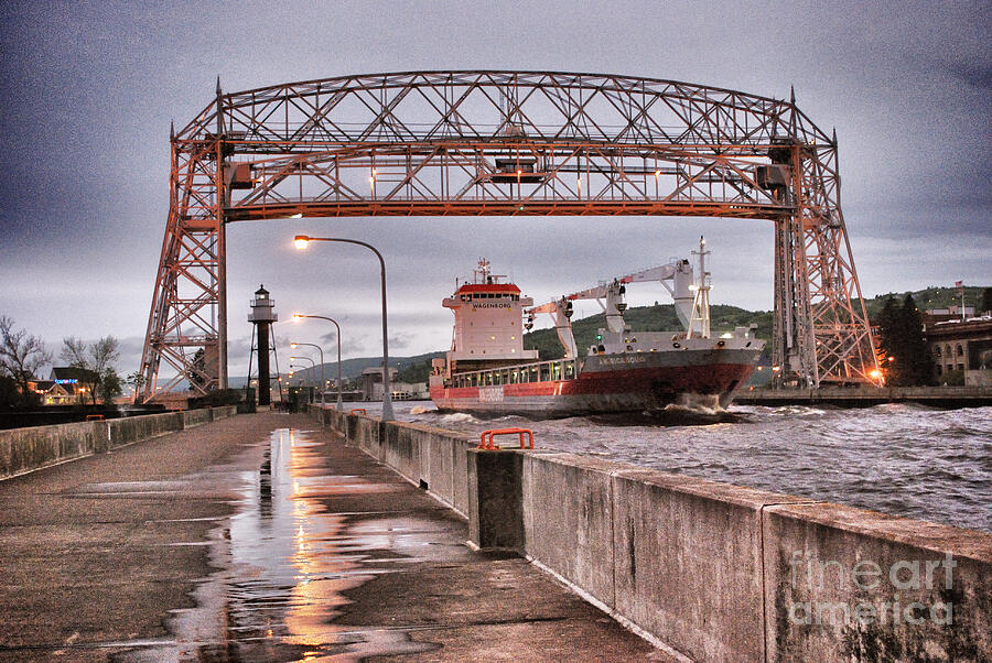 Ship Passing Under Lift Bridge Photograph - Sailing Through The Duluth Aerial Lift Bridge by Duluth To Door County Photography