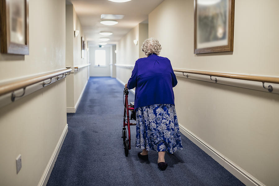 Senior Woman with Walker in a Care Home Photograph by SolStock