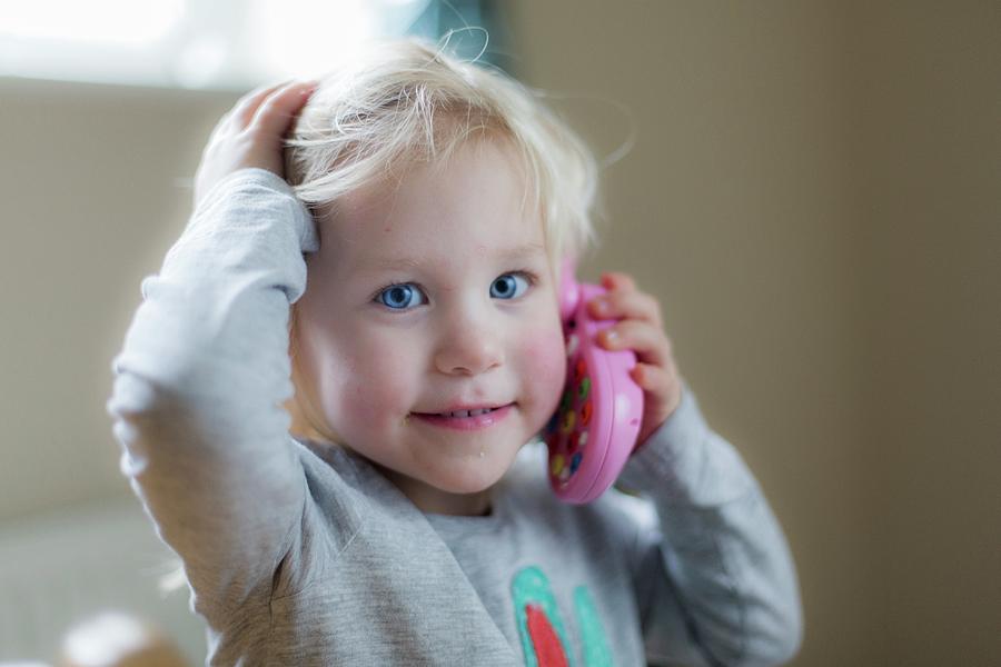 Toddler Playing With Toy Phone by Samuel Ashfield / Science Photo Library