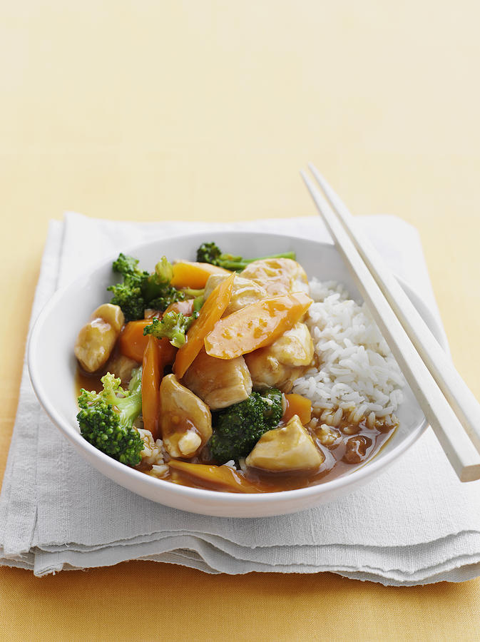 Bowl Of Sweet And Sour Chicken With Rice by Cultura BRETT STEVENS