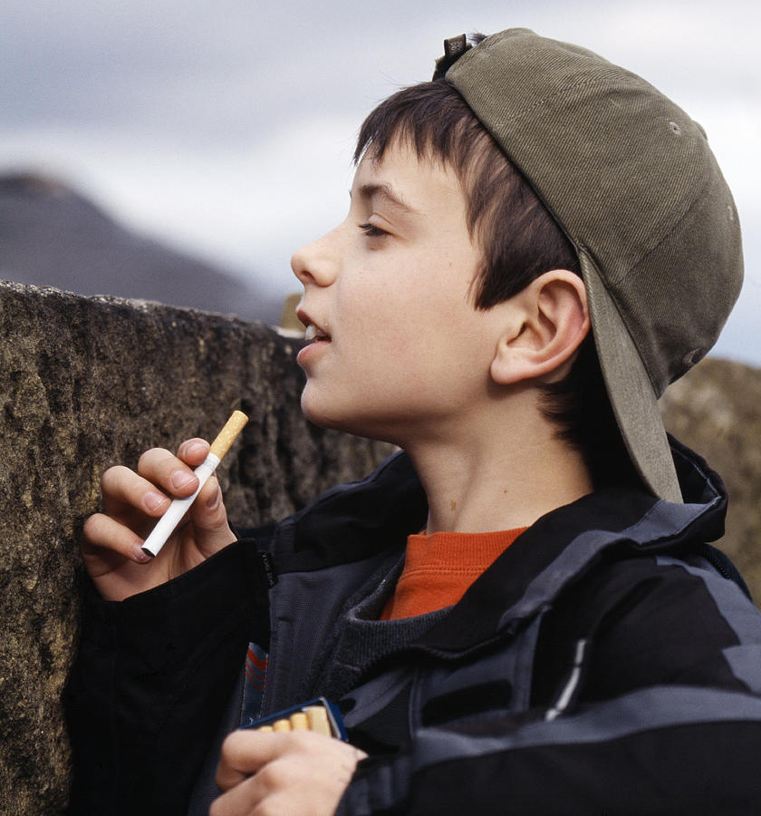 Boy With Cigarettes by Andy Harmer / Science Photo Library