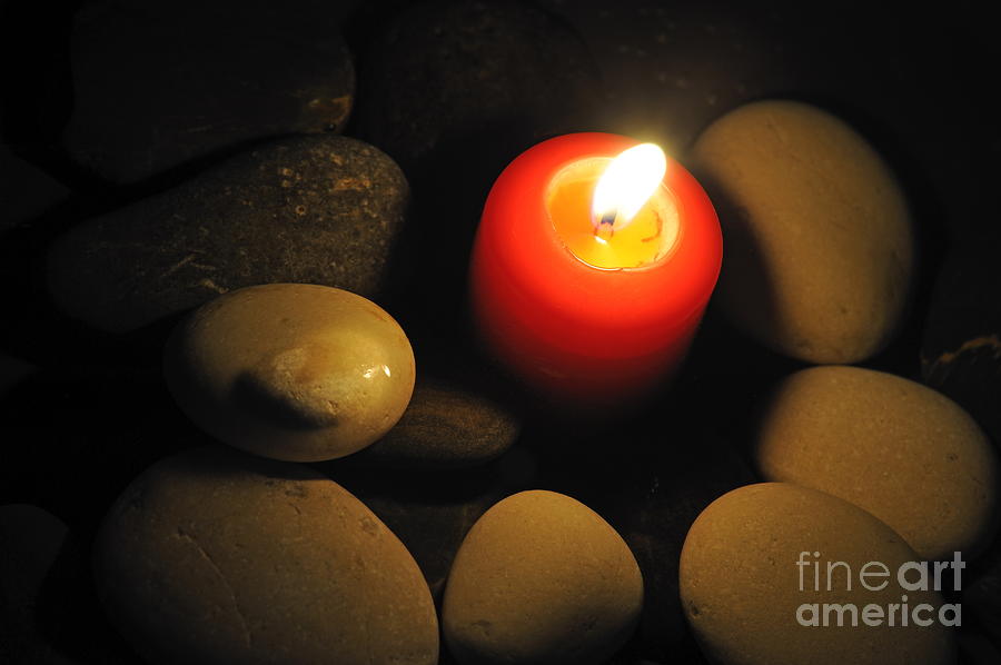 Burning candle with pebbles in water Photograph by Sami Sarkis Photography