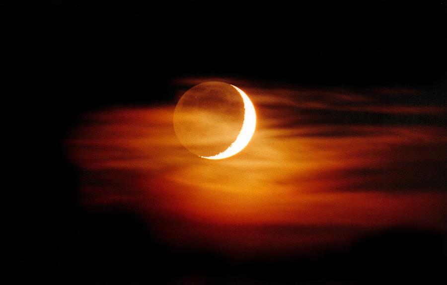 Crescent Moon At Sunset by Laurent Laveder / Science Photo Library