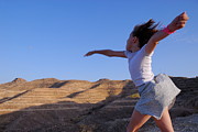 Girl throwing stone in sky Photograph by Sami Sarkis Photography