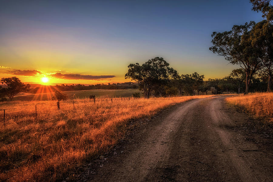 Countryside landscape with rural dirt road at sunset in Australia Photograph by Miroslav Liska