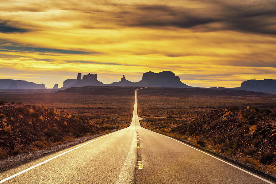 Desert road leading to Monument Valley at sunset Photograph by Miroslav Liska