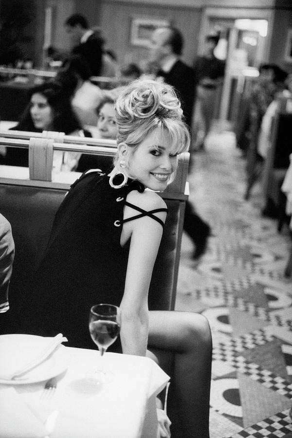 Smiling Woman in a Restaurant Photograph - Claudia Schiffer in Bill Blass Dress by Arthur Elgort
