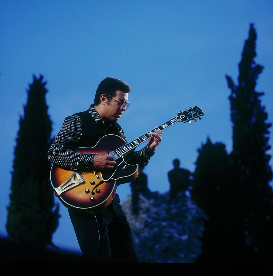 Guitarist Playing in Blue Sky Photograph - Kenny Burrell Performs On Stage by David Redfern