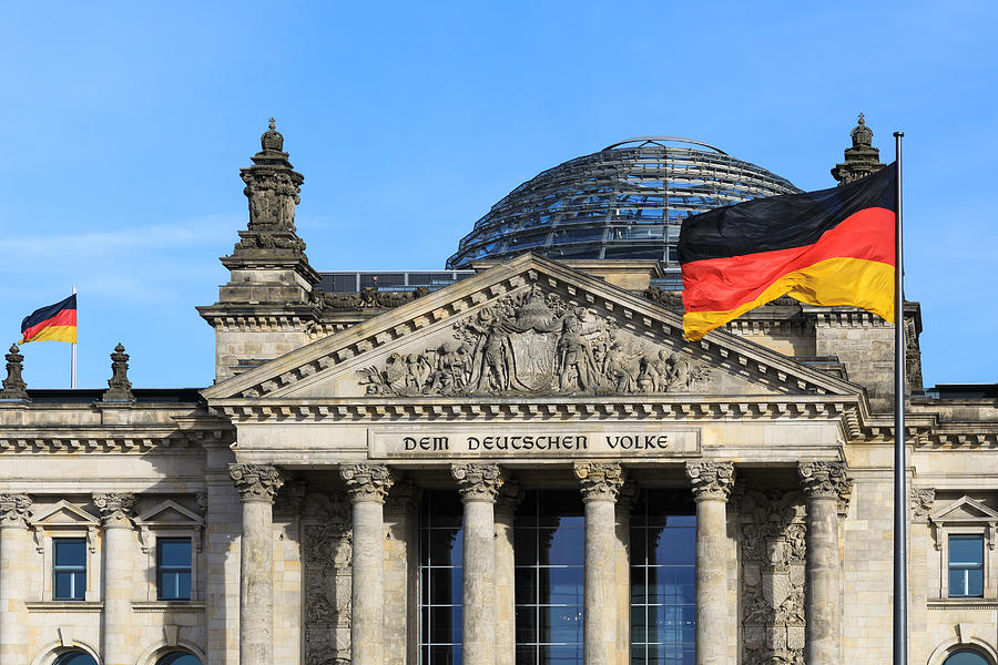 The famous inscription on the architrave on the west portal of the Reichstag building in Berlin: Dem Deutschen Volke with german flag #2 Photograph by Fhm