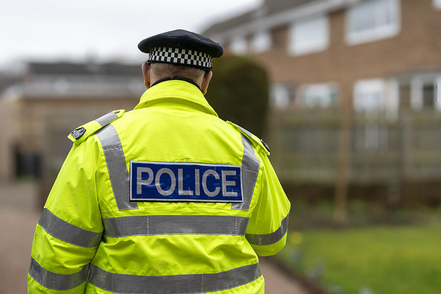 A Policeman Walking Away From An Elderly Persons Home Alphotographic