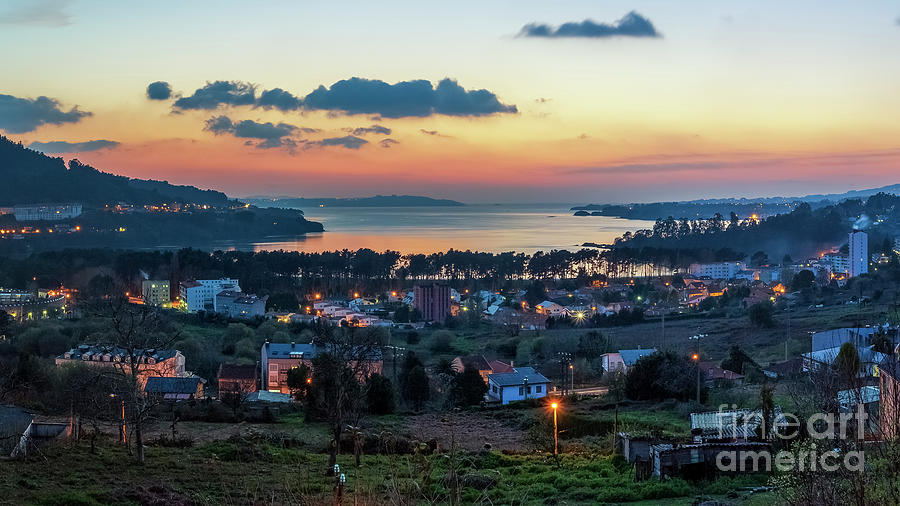 Ares Estuary at dusk seen from Cabanas, A Coruña, Galicia: the original photograph with an orange sky over the ria and street lamps lit in the town below