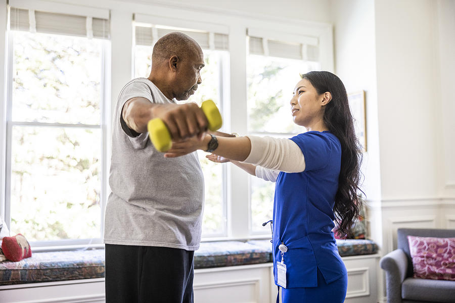 At Home Nurse Helping Senior Man With Physical Therapy At Home Momo Productions