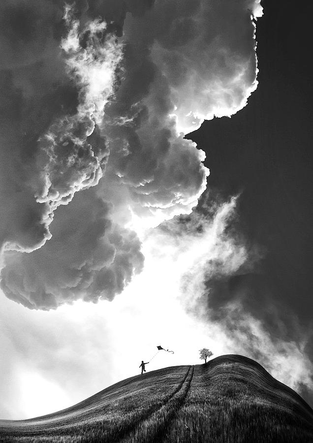 Child Flying Kite Under Dramatic Clouds Photograph - Childhood by Sofie Conte