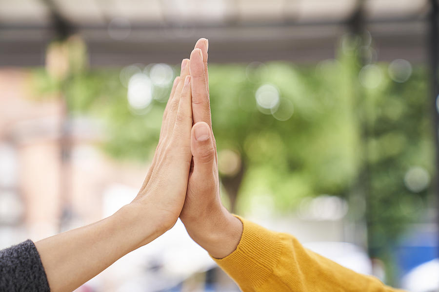 Close-up shot of womens hands high-fiving each other Photograph by PhotoAlto/Ezequiel Sambresqui