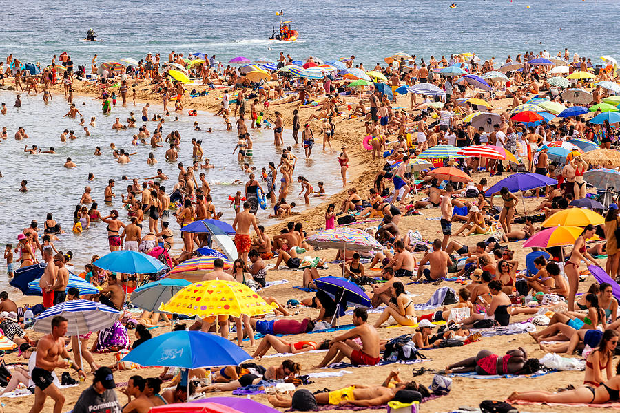 Crowds of tourist on Barceloneta beach, Barcelona, Spain Photograph by Alexander Spatari