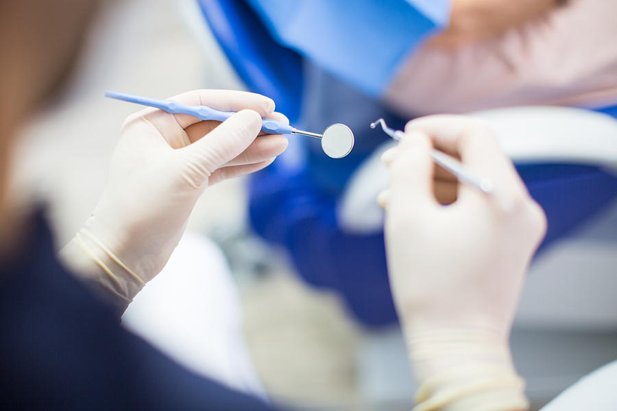 Dentist at work with tools Photograph by Luis Alvarez