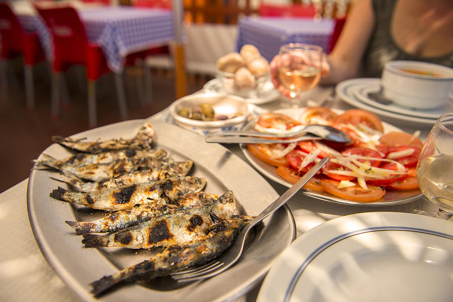 Grilled sardines at an outdoor cafe, Portugal Photograph by Robert George Young