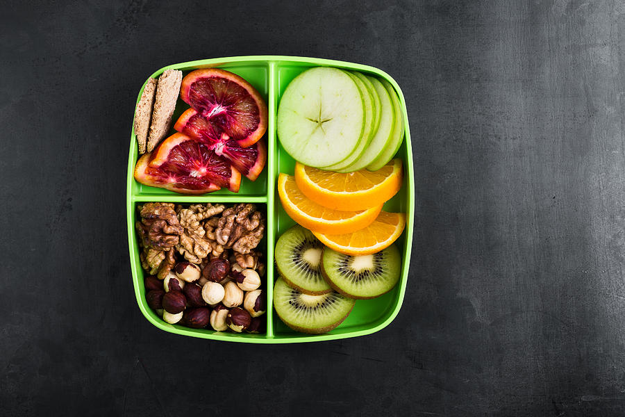 Healthy fruits and nuts snack box Photograph by Istetiana