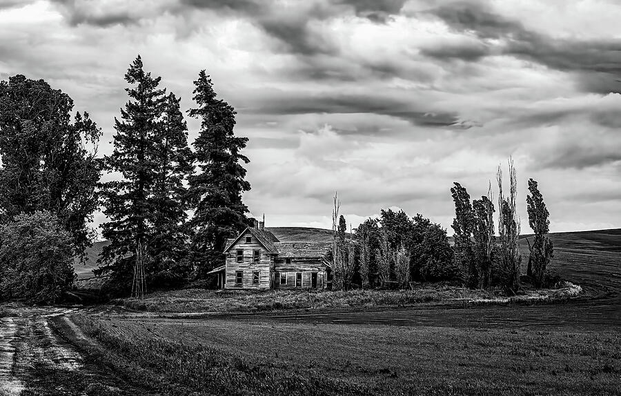 Abandoned House in Vast Farmland Photograph - Homestead Beneath the Storm  Black and White Farmhouse Landscape by Kevin Schwalbe