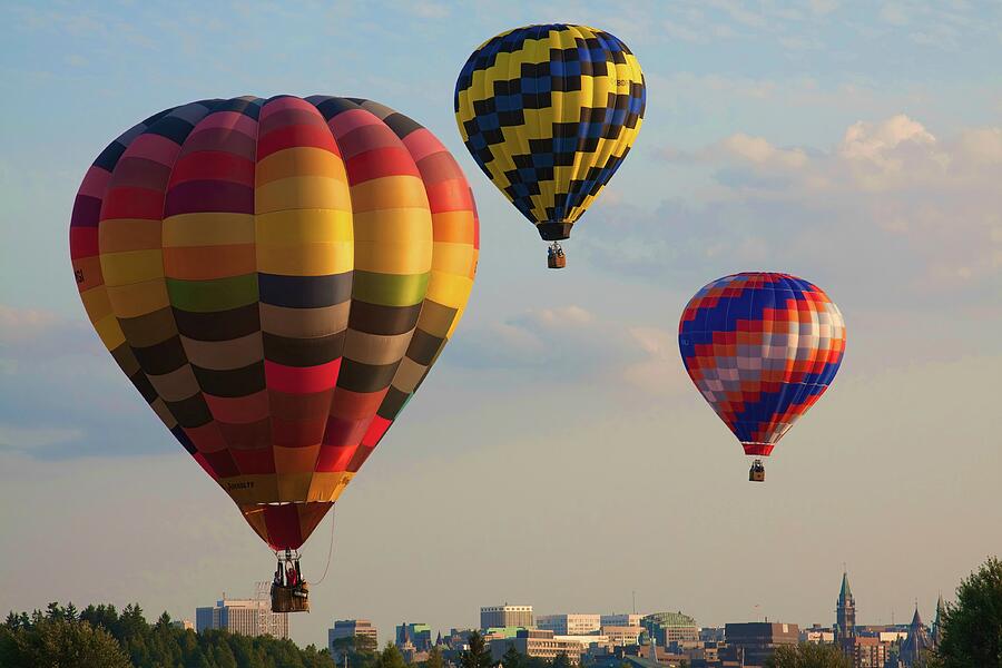 Hot air balloons flying over the city Photograph by Tatiana Travelways