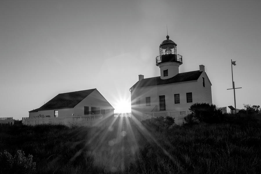 Lighthouse Sun flare Photograph by Gina Cinardo