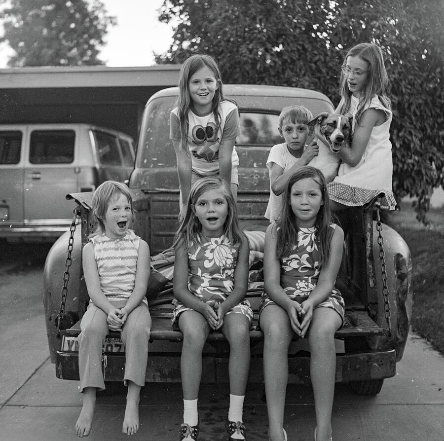Children Sitting on Pickup Truck Photograph - Lively Kids in the Back of a 1949 Ford Pickup, 1971 by Jeremy Butler