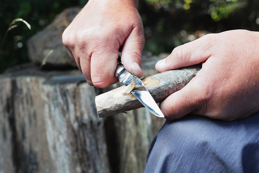 Man Carving Wooden Stick Photograph by Willowpix