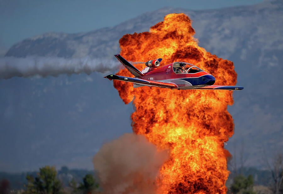 Jet Stunt Over Explosive Display Photograph - Torrey Wards Microjet Blasts Past Fireball - Aerial Precision in Action by Dave Koch - Aircraft Photography