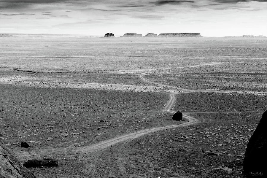 Vast Desert Landscape with Distant Buttes Photograph - Road to Nowhere by Howard Holley