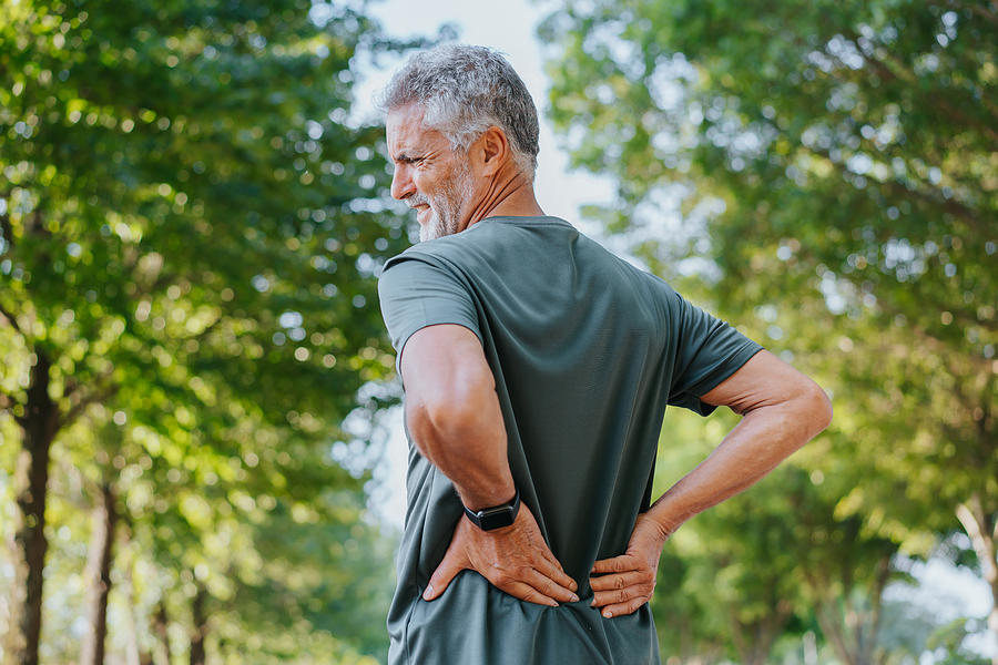 Senior men with back pain Photograph by Andreswd