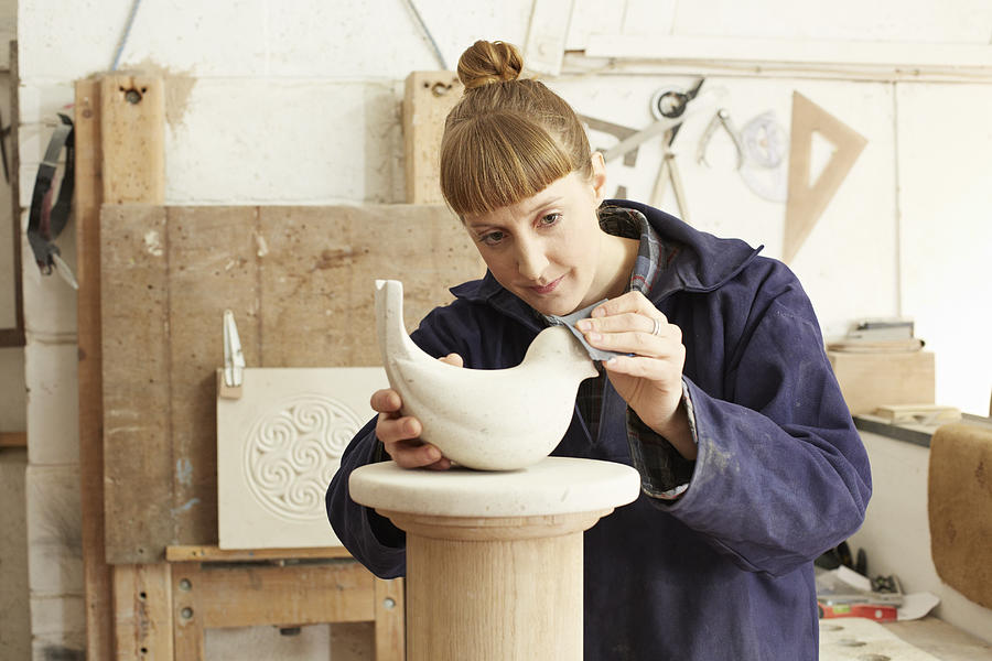 Stone carver sanding sculpture Photograph by Richard Drury