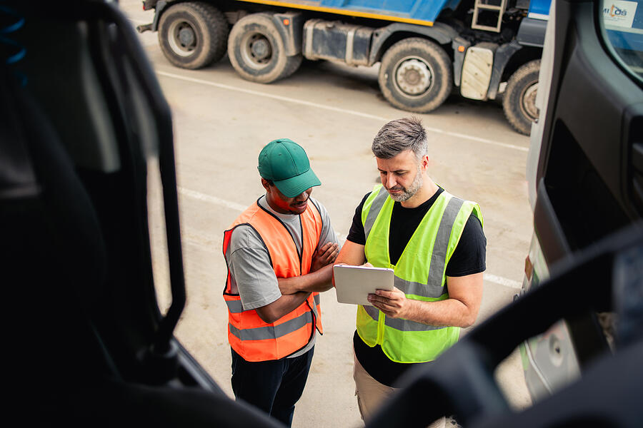 Two Truck Drivers Planning The Transportation Rgstudio
