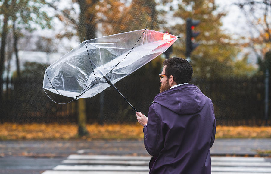 Umbrella caught in the wind Photograph by Luza Studios