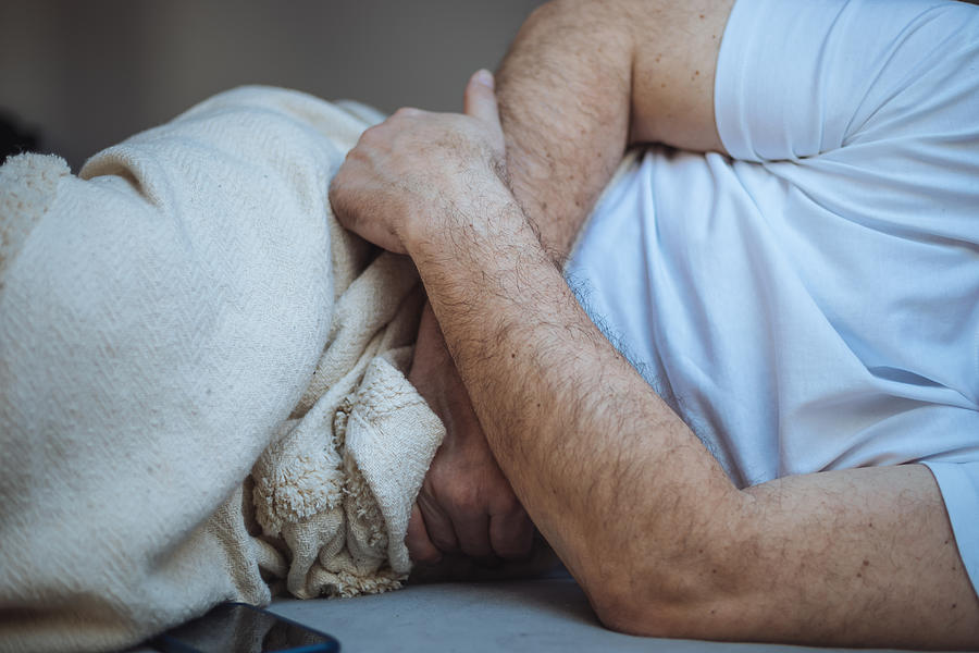 Unrecognizable man stomach pain Photograph by Tatsiana Volkava