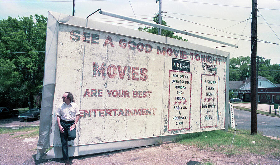 Vintage Movie Billboard in Parking Lot Photograph - Vintage Movie Billboard - Movies Are Your Best Entertainment by Jeremy Butler