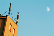Cellular phone antennas and a half moon at sunset Photograph by Sami Sarkis Photography
