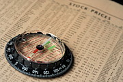 Compass on stockmarket cotation in newspaper Photograph by Sami Sarkis Photography