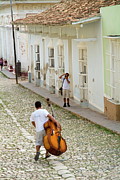 Cuban man carrying a cello Photograph by Sami Sarkis Photography