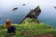Girl sits on a cliff over the ocean in Ireland Photograph by Miroslav Liska