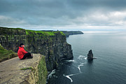 Hiker sitting at the cliffs of Moher Photograph by Miroslav Liska